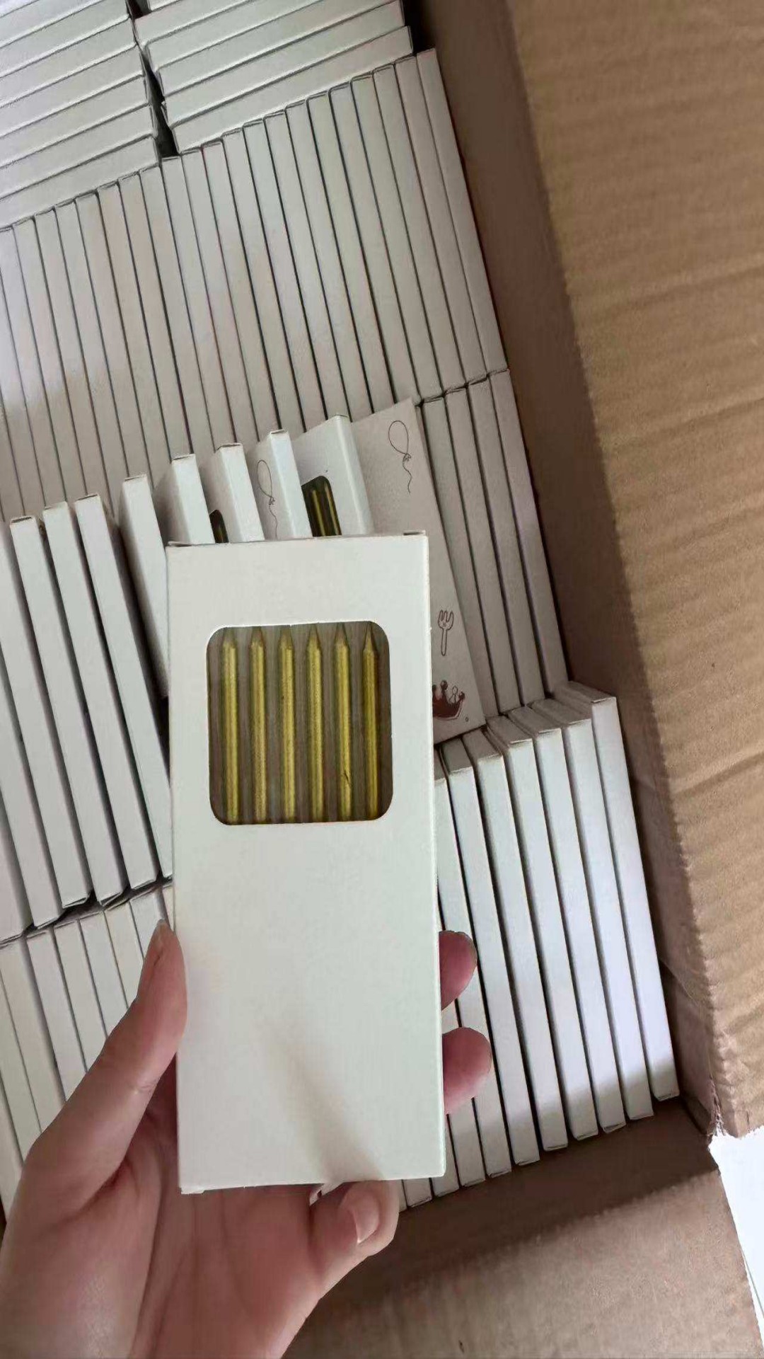 Metallic gold birthday cake candles in retail packaging